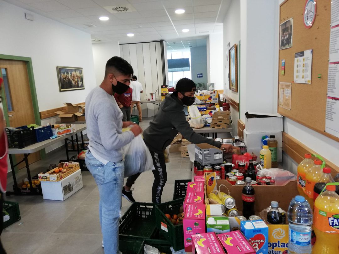 Jóvenes colaboran en el reparto de comida Jóvenes colaboran en el reparto de comida