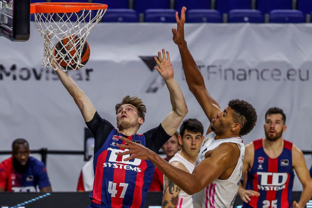 Arturs Kurucs trata de evitar el tapón de Tavares. Arturs Kurucs trata de evitar el tapón de Tavares.
