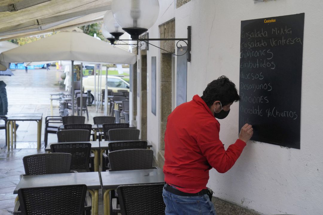 Un hombre escribe en la pizarra de un mesón, en Santiago de Compostela, A Coruña, Galicia (España), a 4 de diciembre de 2020. Hoy se reabre la hostelería en toda Galicia, aunque en distinto grado en función de los datos de los contagios de coronavirus, y Un hombre escribe en la pizarra de un mesón, en Santiago de Compostela, A Coruña, Galicia (España), a 4 de diciembre de 2020. Hoy se reabre la hostelería en toda Galicia, aunque en distinto grado en función de los datos de los contagios de coronavirus, y