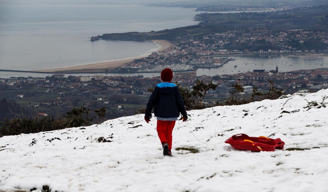 Un niño observa Hondarribia y Hendaia desde un monte Jaizkibel nevado esta semana. Un niño observa Hondarribia y Hendaia desde un monte Jaizkibel nevado esta semana.