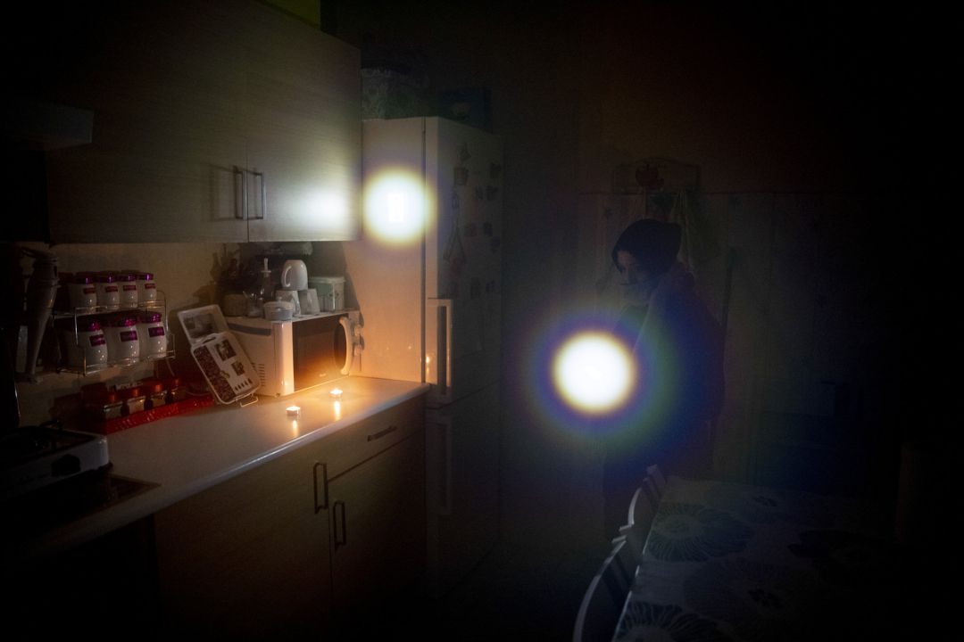 Una mujer emplea una linterna para iluminar su casa, a oscuras por los cortes de luz en la Cañada Real Una mujer emplea una linterna para iluminar su casa, a oscuras por los cortes de luz en la Cañada Real