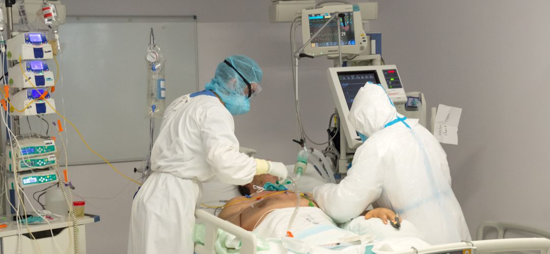 Dos sanitarios atienden a un paciente con coronavirus Dos sanitarios atienden a un paciente con coronavirus