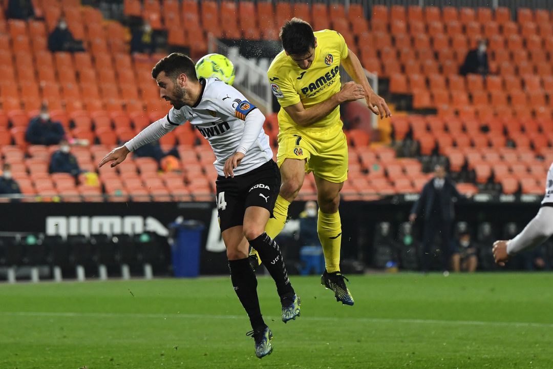 VALENCIA, SPAIN - MARCH 05: Gerard Moreno of Villareal heads against the arm of Jose Gaya of Valencia which lead to a penalty being awarded after a review by VAR during the La Liga Santander match between Valencia CF and Villarreal CF at Estadio Mestalla on March 05, 2021 in Valencia, Spain. Sporting stadiums around Spain remain under strict restrictions due to the Coronavirus Pandemic as Government social distancing laws prohibit fans inside venues resulting in games being played behind closed doors. VALENCIA, SPAIN - MARCH 05: Gerard Moreno of Villareal heads against the arm of Jose Gaya of Valencia which lead to a penalty being awarded after a review by VAR during the La Liga Santander match between Valencia CF and Villarreal CF at Estadio Mestalla on March 05, 2021 in Valencia, Spain. Sporting stadiums around Spain remain under strict restrictions due to the Coronavirus Pandemic as Government social distancing laws prohibit fans inside venues resulting in games being played behind closed doors.