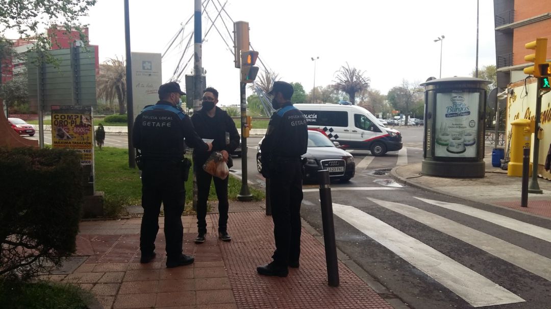 Dos policías locales de Getafe informan a un vecino de las restricciones en la ZBS de Las Margaritas, que mantiene esas medidas, al menos, hasta el domingo. Dos policías locales de Getafe informan a un vecino de las restricciones en la ZBS de Las Margaritas, que mantiene esas medidas, al menos, hasta el domingo.
