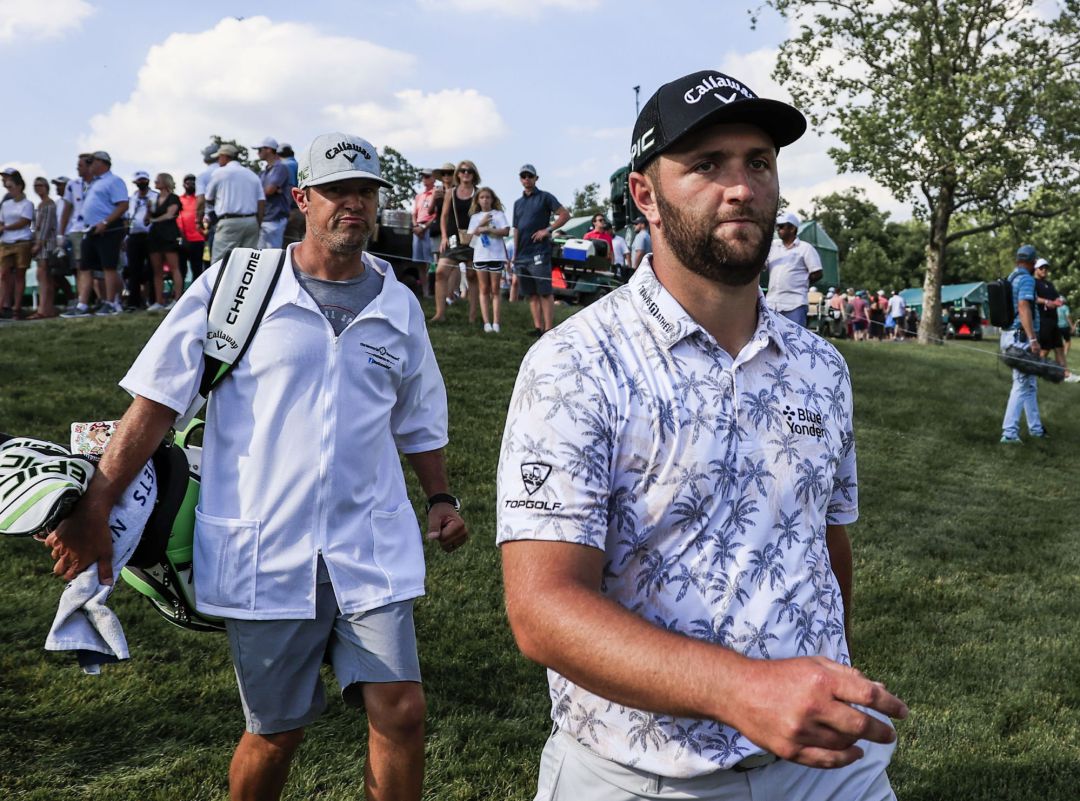 Jon Rahm of Spain (R) is followed by caddie Adam Hayes as they walk to the seventeenth tee during the third round of The Memorial golf tournament at Muirfield Village Golf Club in Dublin, Ohio, USA, Jon Rahm of Spain (R) is followed by caddie Adam Hayes as they walk to the seventeenth tee during the third round of The Memorial golf tournament at Muirfield Village Golf Club in Dublin, Ohio, USA,