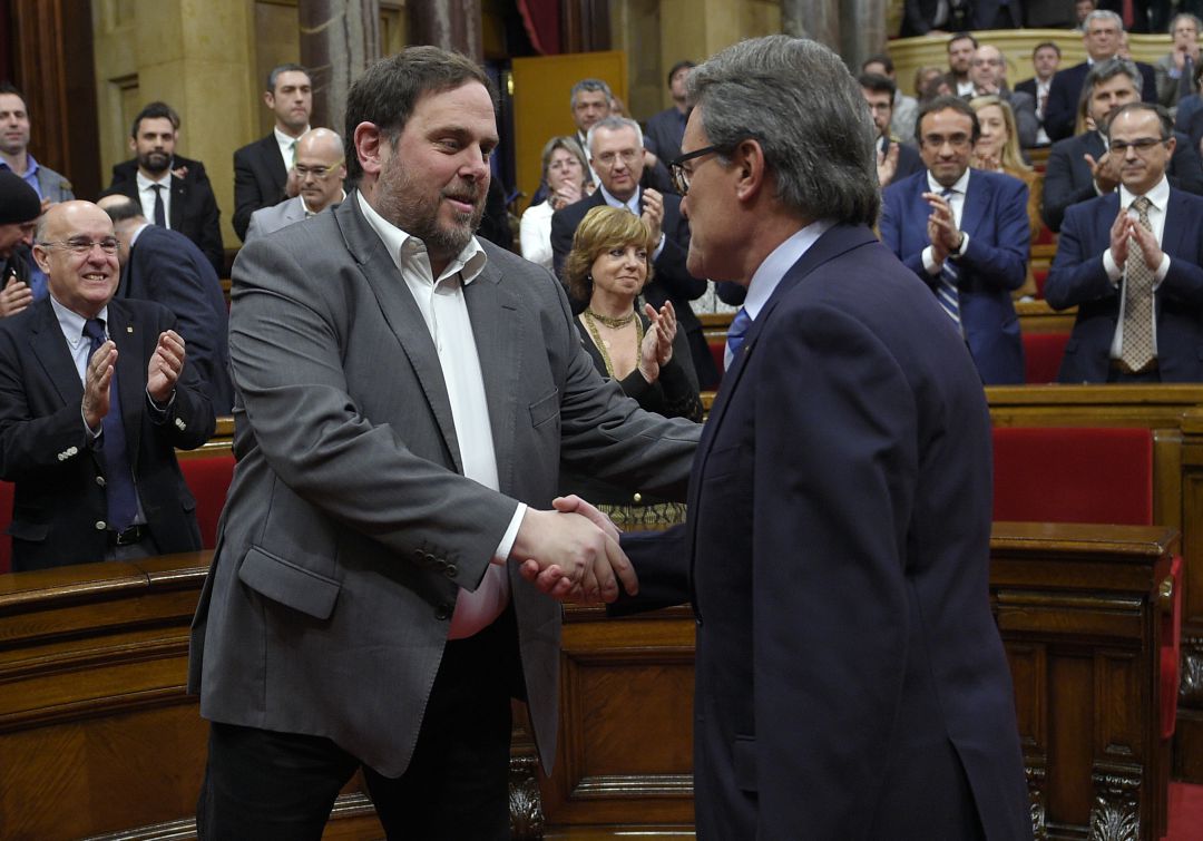 Artur Mas y Oriol Junqueras se estrechan la mano durante una sesión del Parlament. Artur Mas y Oriol Junqueras se estrechan la mano durante una sesión del Parlament.