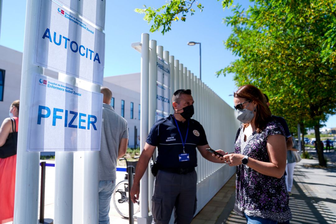Un policía controla la entrada de varias personas a las afueras del Hospital público de emergencias Enfermera Isabel Zendal, Un policía controla la entrada de varias personas a las afueras del Hospital público de emergencias Enfermera Isabel Zendal,
