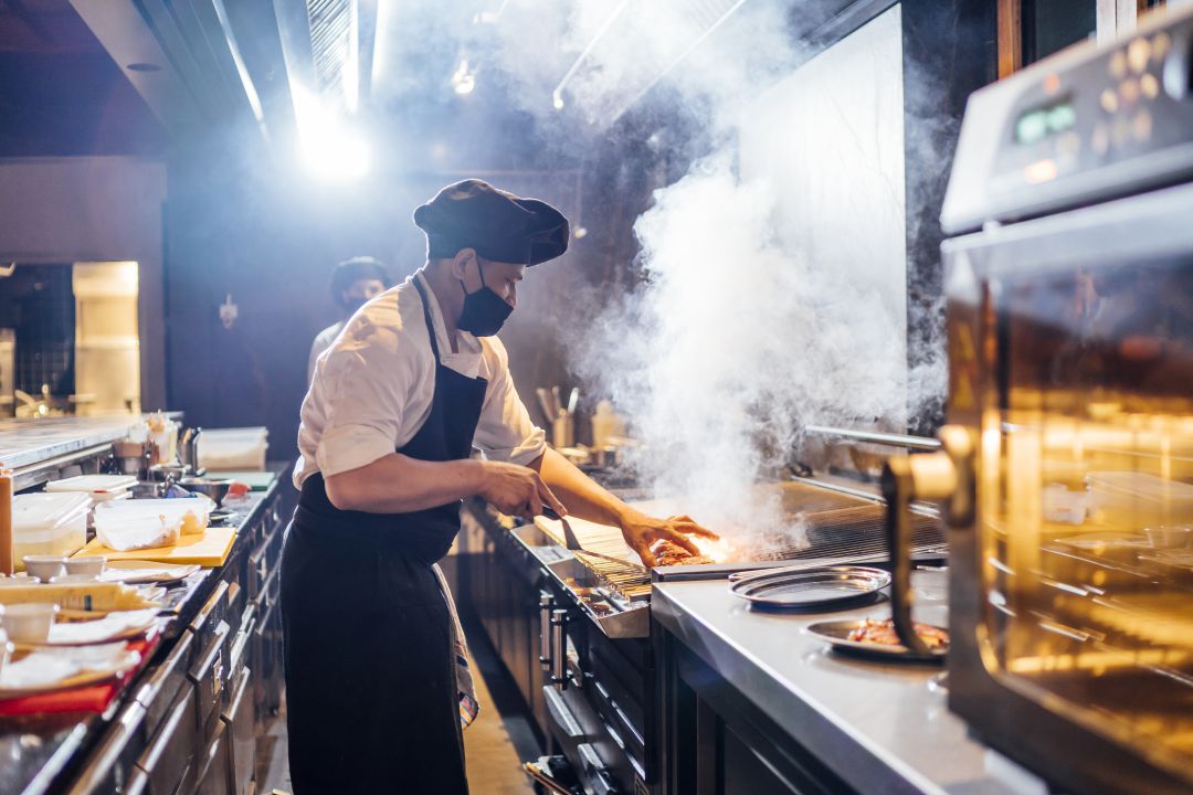 Chef preparando una comida en la cocina de un restaurante. Chef preparando una comida en la cocina de un restaurante.