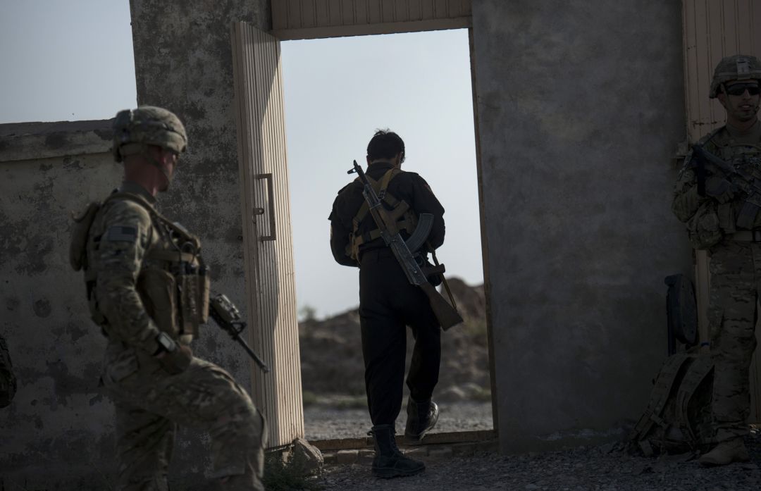 Un miembro de la policía afgana y soldados estadounidenses cerca del aeródromo de Kandahar. Un miembro de la policía afgana y soldados estadounidenses cerca del aeródromo de Kandahar.