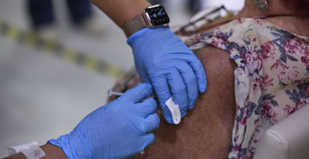 Una sanitaria vacuna a una mujer con la tercera dosis de la vacuna de la covid-19. Una sanitaria vacuna a una mujer con la tercera dosis de la vacuna de la covid-19.