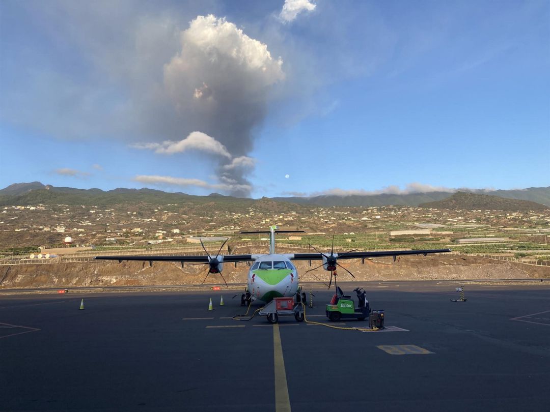 Un avión de Binter en la pista del aeropuerto de La Palma, con el volcán en erupción al fondo - BINTER Un avión de Binter en la pista del aeropuerto de La Palma, con el volcán en erupción al fondo - BINTER