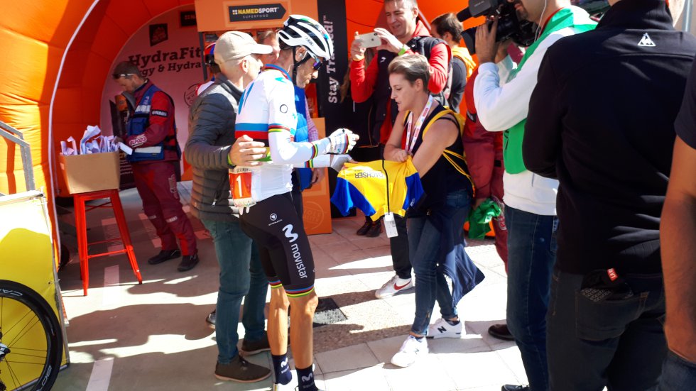 El campeón del mundo, Alejandro Valverde, firma un maillot a una aficionada.