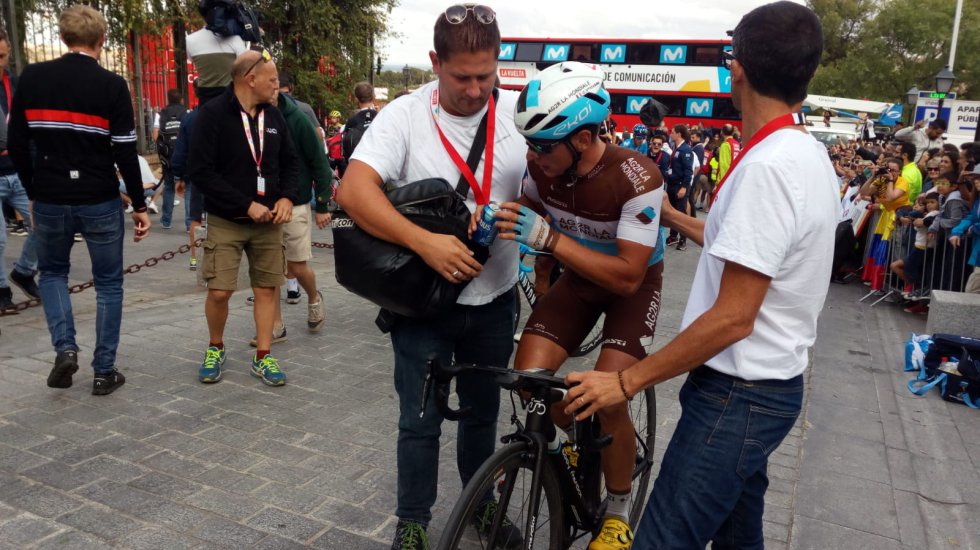 Oficiales de los equipos atienden a los ciclistas recién llegados Oficiales de los equipos atienden a los ciclistas recién llegados