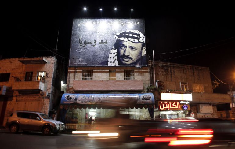 TO GO WITH ARAFAT 10 YEARS PACKAGE  A picture taken on November 3, 2014, shows a giant portrait of late Palestinian leader Yasser Arafat displayed on a street in the Arab east Jerusalem neighbourhood of Beit Hanina. Arafat's death on November 11, 2004 still remains a mystery with some research indicating he may have been poisoned by polonium, a theory which is accepted by much of the Palestinian street. AFP PHOTO / AHMAD GHARABLI