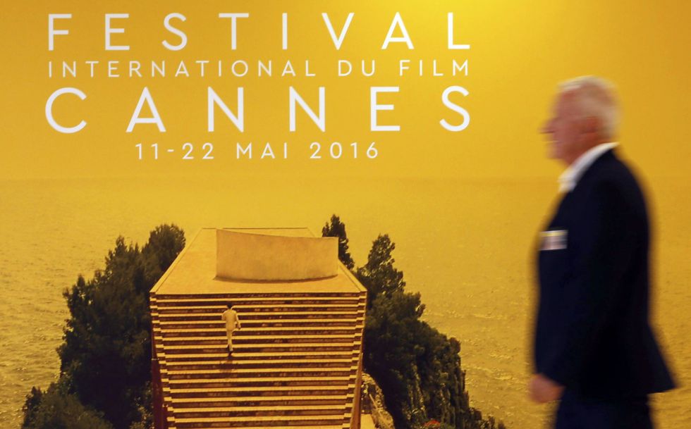 A man walks past an official poster of the 69th Cannes Film Festival inside the Festival Palace on the eve of the opening ceremony in Cannes, France, May 10, 2016. REUTERS/Regis Duvignau A man walks past an official poster of the 69th Cannes Film Festival inside the Festival Palace on the eve of the opening ceremony in Cannes, France, May 10, 2016. REUTERS/Regis Duvignau