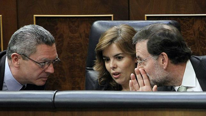 Aberto Ruiz Gallardón, Soraya Sáenz de Santamaría y Mariano Rajoy conversan en el Congreso.