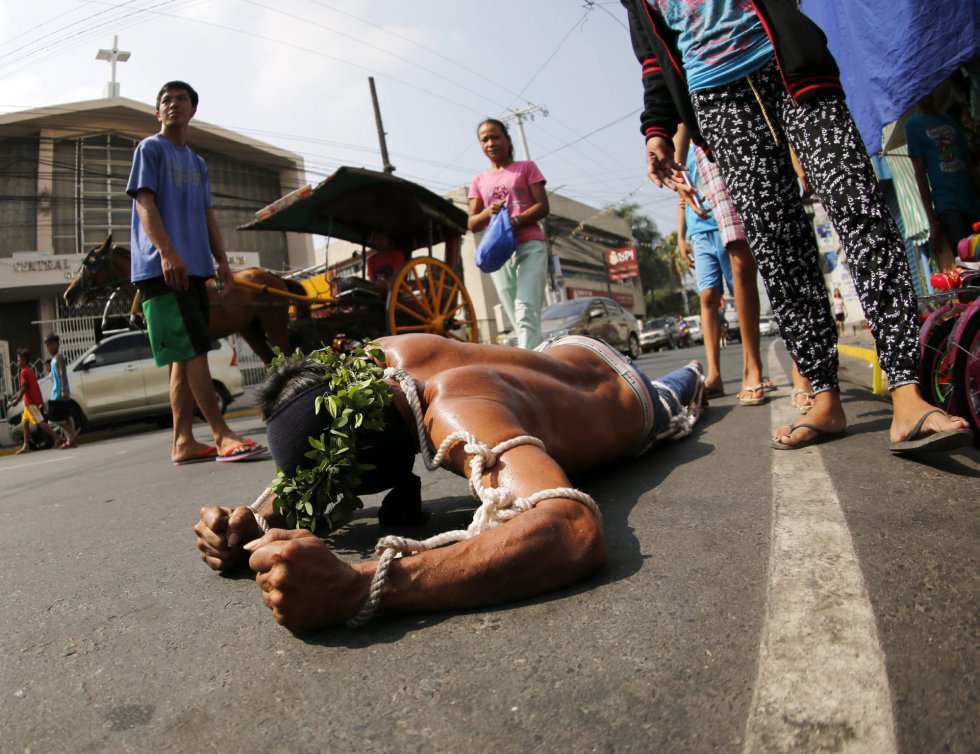 Un penitente se arrastra por el suelo para llegar a la iglesia en San Pedro Cutud en San Fernando al norte de Manila (Filipinas). Un penitente se arrastra por el suelo para llegar a la iglesia en San Pedro Cutud en San Fernando al norte de Manila (Filipinas).