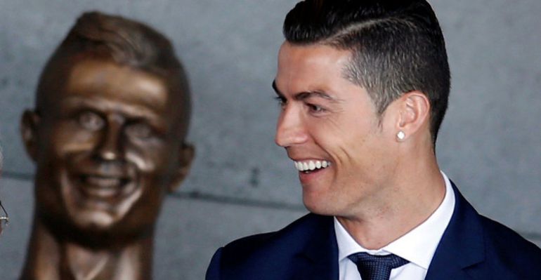 Cristiano Ronaldo, con el busto que figura en el aeropuerto de Madeira que lleva su nombre.
