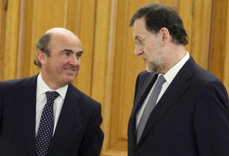 Luis de Guindos y Mariano Rajoy.