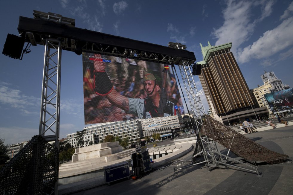 Pantalla gigante instalada en la madrileña Plaza de Colón con la retransmisión del desfile de Día de la Fiesta Nacional. El desfile ha consistido en un homenaje a los caídos y un desfile terrestre y aéreo por el paseo de la Castellana, en el que han participado unos 3.900 efectivos, entre militares de los tres Ejércitos, guardias civiles, policías y Guardia Real, 84 vehículos y 78 aeronaves. Pantalla gigante instalada en la madrileña Plaza de Colón con la retransmisión del desfile de Día de la Fiesta Nacional. El desfile ha consistido en un homenaje a los caídos y un desfile terrestre y aéreo por el paseo de la Castellana, en el que han participado unos 3.900 efectivos, entre militares de los tres Ejércitos, guardias civiles, policías y Guardia Real, 84 vehículos y 78 aeronaves.
