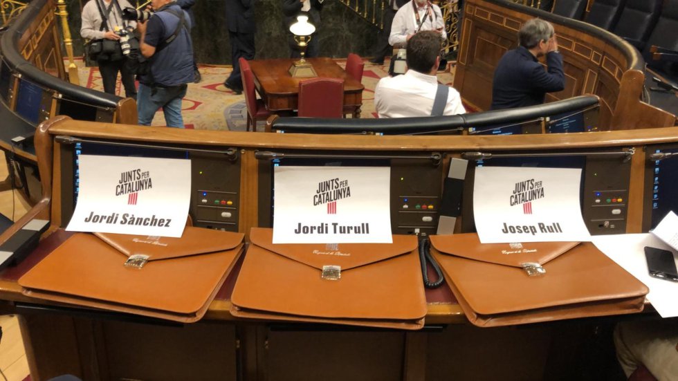 Las carteras de Jordi Sànchez, Josep Rull y Jordi Turull en los escaños que sus compañeros de JxCatles habían reservado en el hemiciclo.