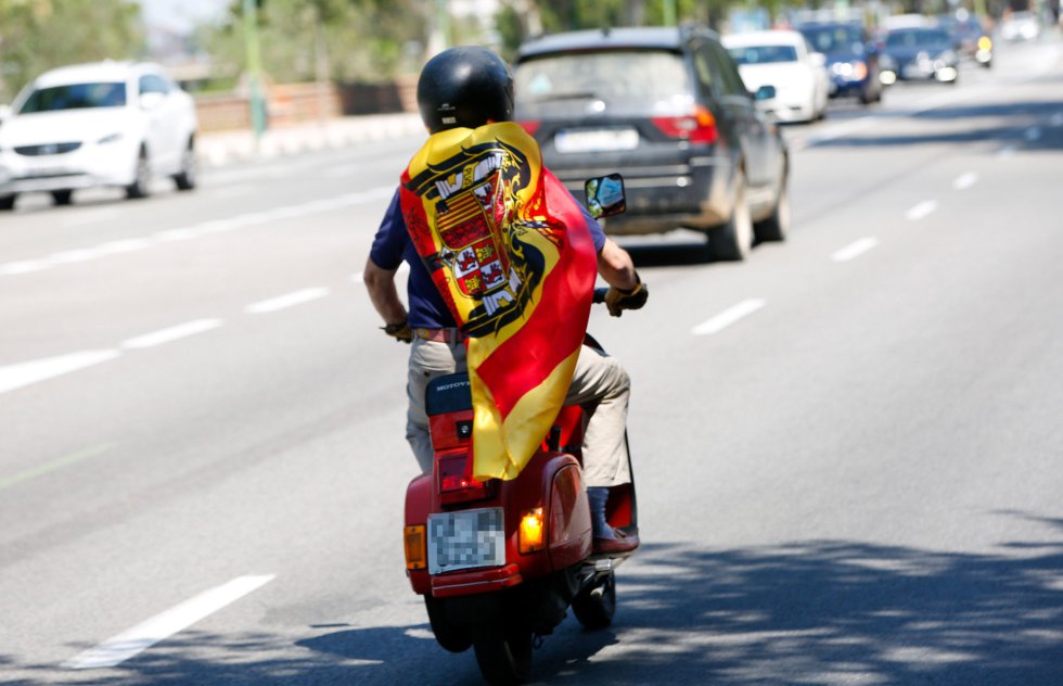 Un joven con una bandera pre-constitucional se adelanta a la caravana de coches convocada por Vox contra la gestión del Gobierno de Pedro Sánchez en la crisis del coronavirus. Un joven con una bandera pre-constitucional se adelanta a la caravana de coches convocada por Vox contra la gestión del Gobierno de Pedro Sánchez en la crisis del coronavirus.