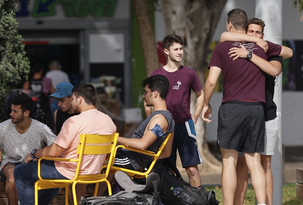 Dos amigos se abrazan en el primer día sin uso obligatorio de mascarillas al aire libre en Israel. Dos amigos se abrazan en el primer día sin uso obligatorio de mascarillas al aire libre en Israel.