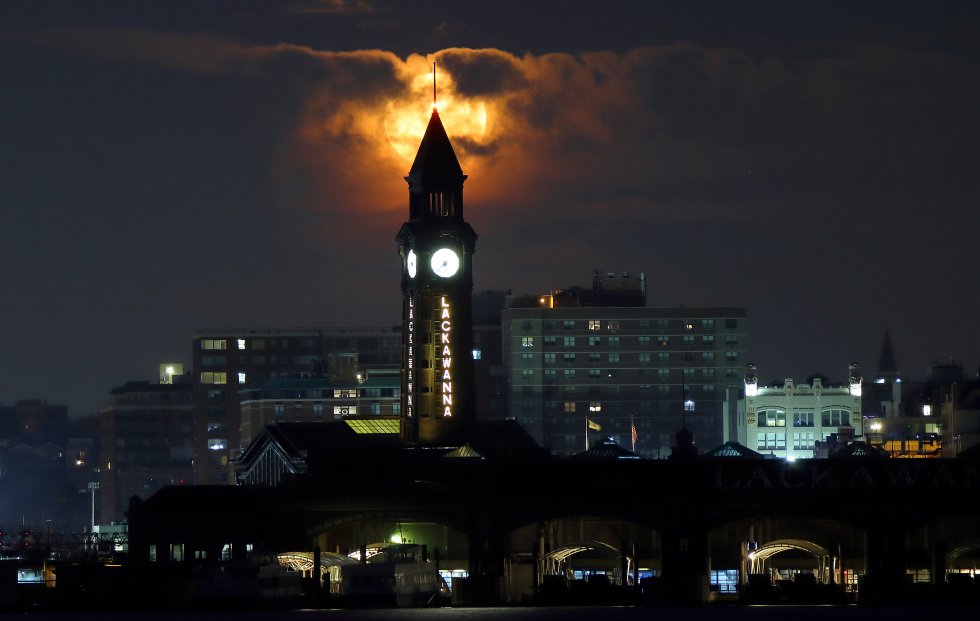 El comportamiento de la luna detrás de la torre del reloj de Lackawanna antes del alba en Hoboken, Nueva Jersey. El comportamiento de la luna detrás de la torre del reloj de Lackawanna antes del alba en Hoboken, Nueva Jersey.