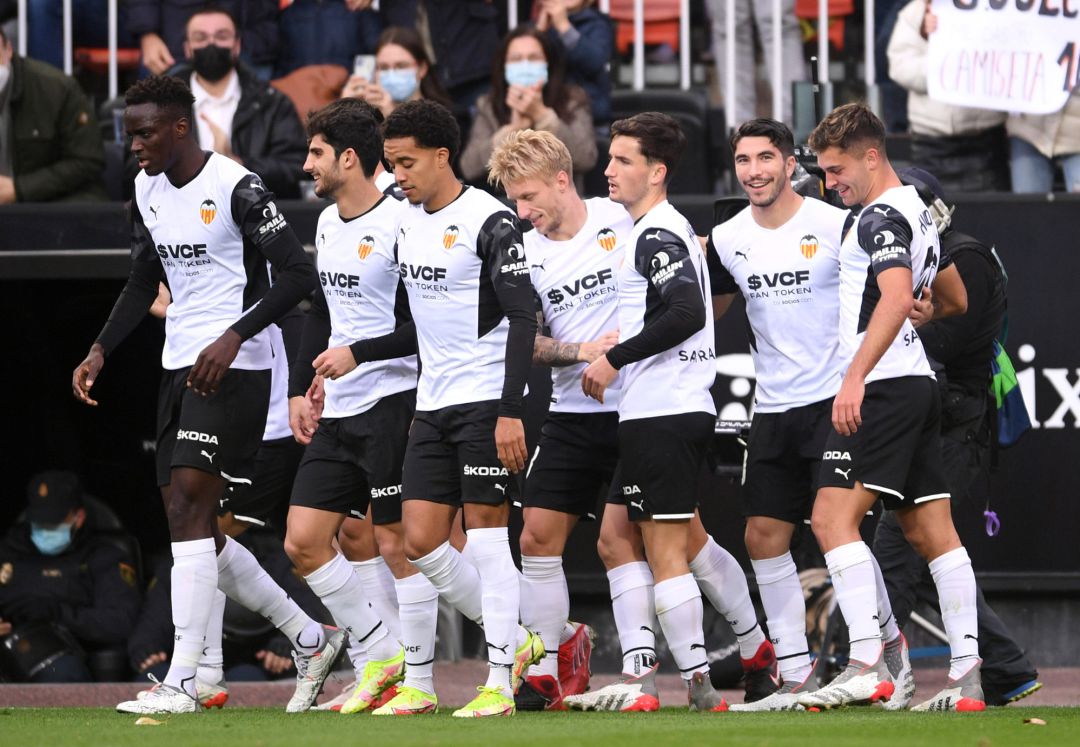 Carlos Soler of Valencia CF celebrates with teammates after scoring their team's first goal during the La Liga Santander match between Valencia CF